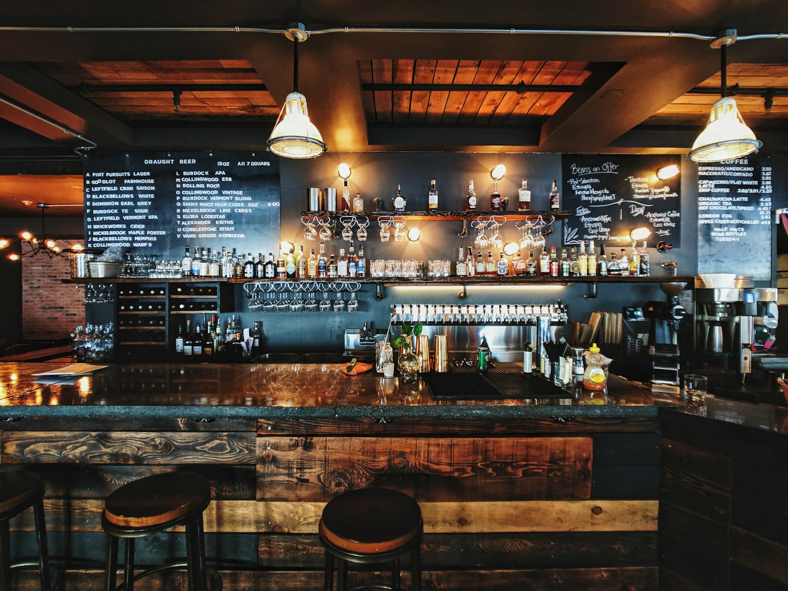 Modern lively craft brewery bar counter with bartender tapping craft draft beer