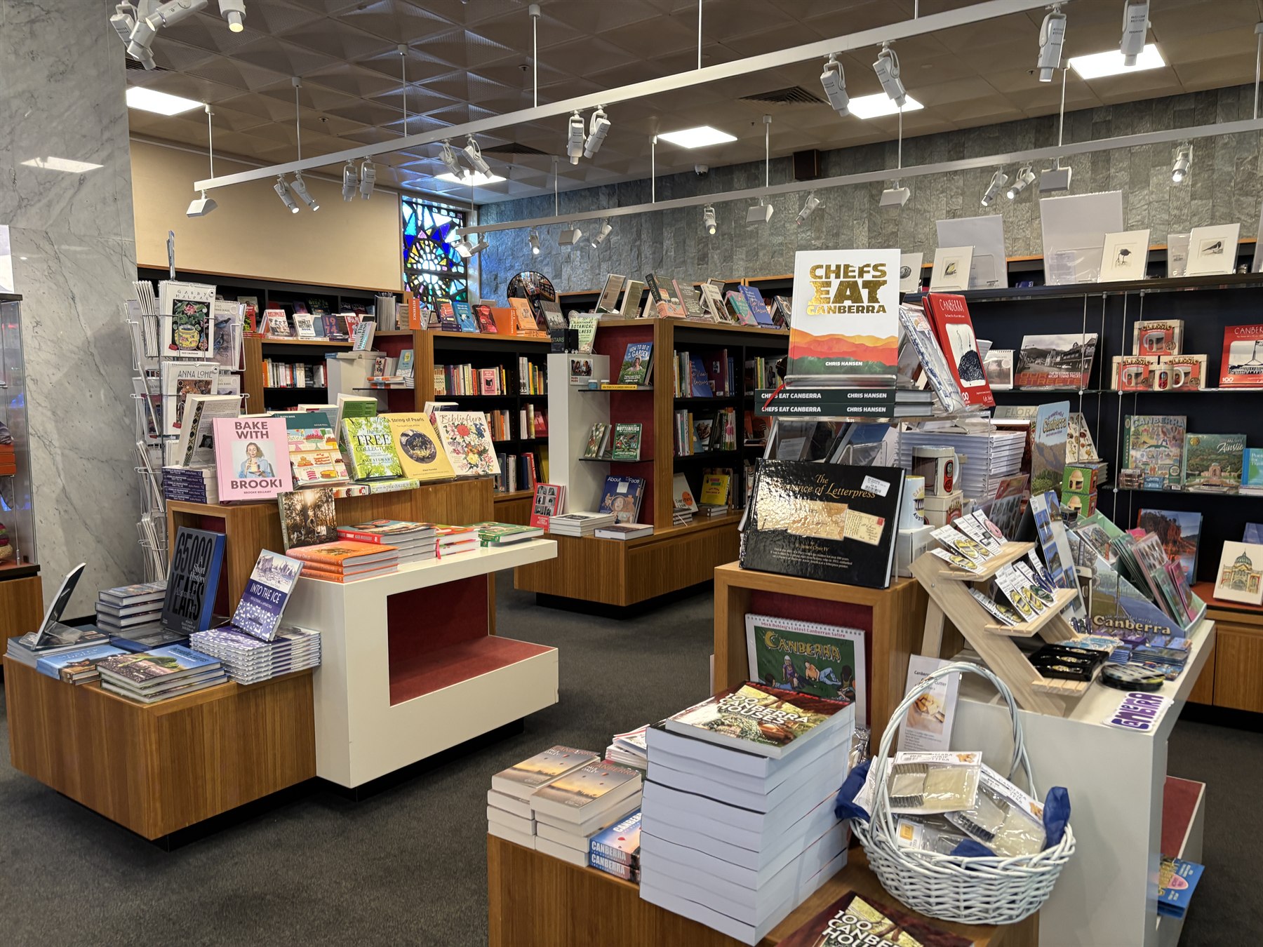 Students and parents browsing educational syllabus kits in a vibrant campus bookstore